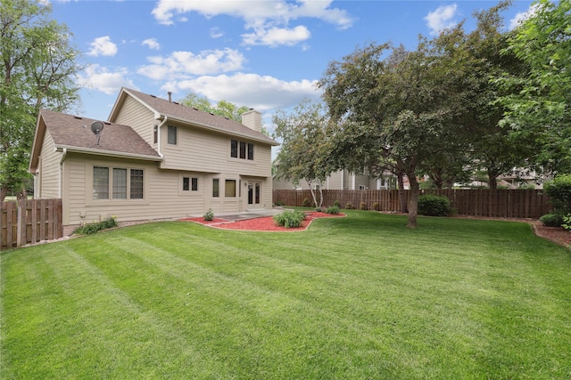 313 29th St, West Des Moines, IA 50265 - back of house with a chimney, a patio area, and roof with shingles