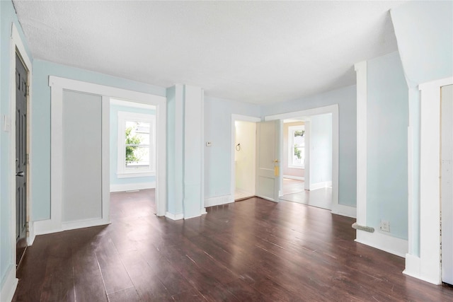 1127 10th St, Des Moines, IA 50314 - spare room featuring plenty of natural light, wood finished floors, and baseboards