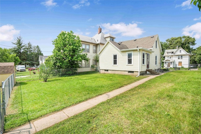 1127 10th St, Des Moines, IA 50314 - back of house featuring a shingled roof, entry steps, and a chimney