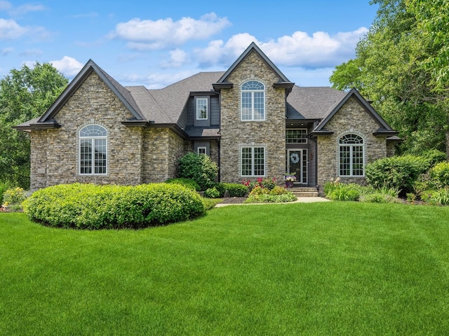 11576 NW Timberbrooke Ln, Grimes, IA 50111 - view of front of home featuring stone siding, a front lawn, and a shingled roof
