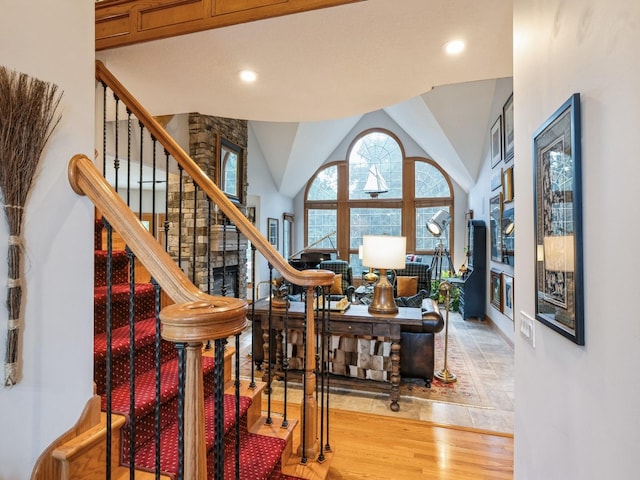 11576 NW Timberbrooke Ln, Grimes, IA 50111 - stairway featuring wood finished floors, recessed lighting, and vaulted ceiling