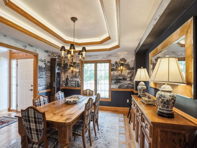 11576 NW Timberbrooke Ln, Grimes, IA 50111 - dining area with a raised ceiling, a chandelier, baseboards, wainscoting, and crown molding