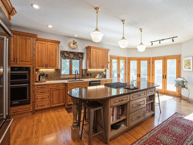 11576 NW Timberbrooke Ln, Grimes, IA 50111 - kitchen with french doors, open shelves, a sink, dishwasher, and backsplash