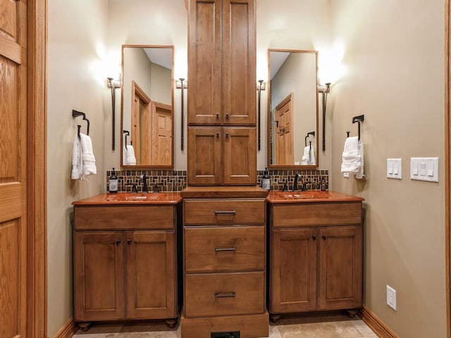 11576 NW Timberbrooke Ln, Grimes, IA 50111 - bathroom with double vanity, decorative backsplash, and baseboards