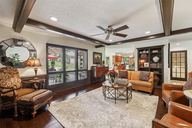 14091 Willow Dr, Clive, IA 50325 - living area featuring ceiling fan, a textured ceiling, dark wood-style floors, beam ceiling, and wainscoting
