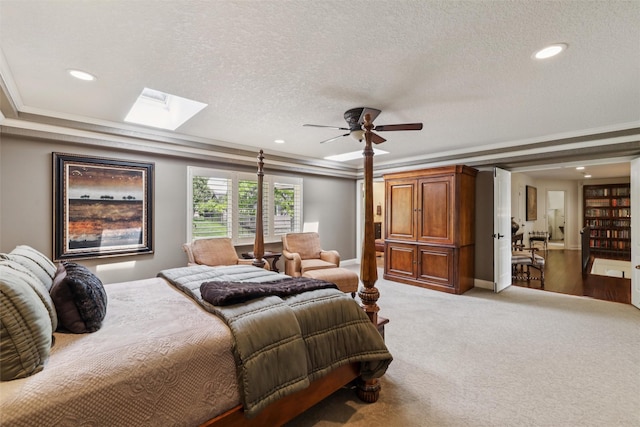 14091 Willow Dr, Clive, IA 50325 - bedroom with crown molding, recessed lighting, a textured ceiling, carpet flooring, and a skylight