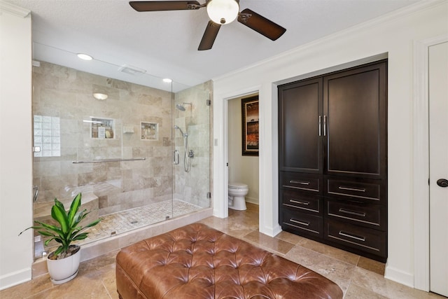 14091 Willow Dr, Clive, IA 50325 - full bathroom featuring toilet, a stall shower, ceiling fan, ornamental molding, and baseboards