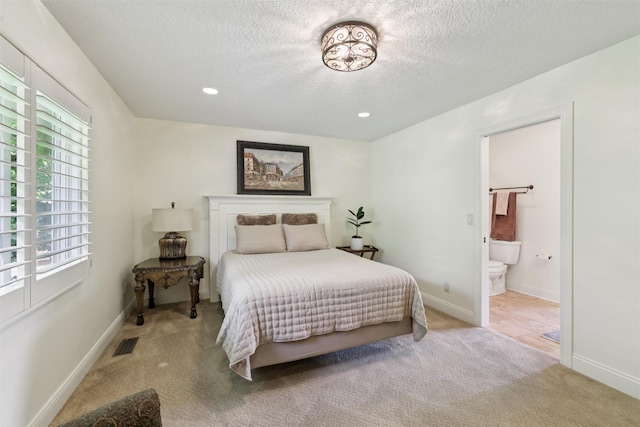 14091 Willow Dr, Clive, IA 50325 - carpeted bedroom featuring a textured ceiling, ensuite bathroom, recessed lighting, and baseboards