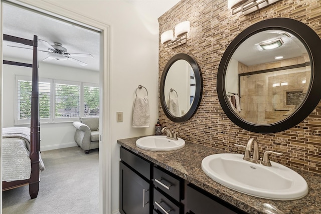 14091 Willow Dr, Clive, IA 50325 - full bathroom with ensuite bath, backsplash, a ceiling fan, double vanity, and baseboards