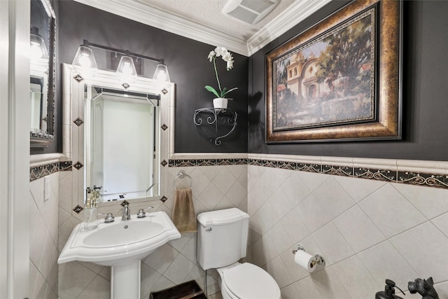 14091 Willow Dr, Clive, IA 50325 - half bath with toilet, crown molding, wainscoting, and tile walls