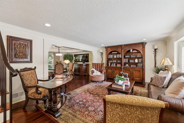 14091 Willow Dr, Clive, IA 50325 - living area featuring a textured ceiling, wood finished floors, crown molding, recessed lighting, and baseboards