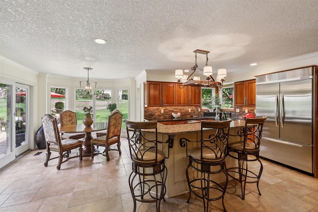 14091 Willow Dr, Clive, IA 50325 - kitchen with built in refrigerator, a chandelier, healthy amount of natural light, a textured ceiling, and recessed lighting