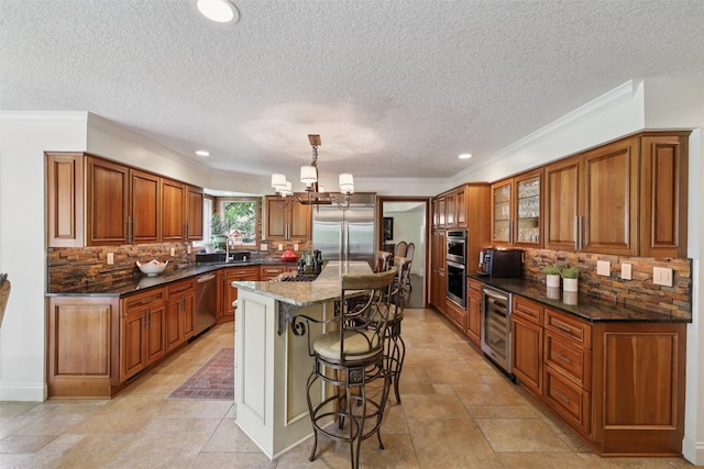 14091 Willow Dr, Clive, IA 50325 - kitchen featuring stainless steel appliances, wine cooler, brown cabinets, a textured ceiling, and recessed lighting