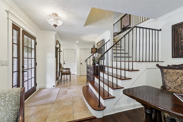 14091 Willow Dr, Clive, IA 50325 - foyer with stairs, a textured ceiling, baseboards, ornamental molding, and french doors