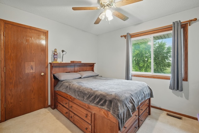 1290 S 4th St, Carlisle, IA 50047 - bedroom with light colored carpet, a ceiling fan, and baseboards