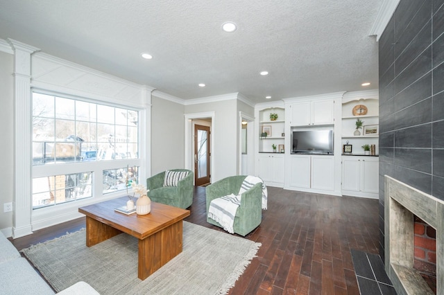 4005 Beaver Ave, Des Moines, IA 50310 - living area featuring dark wood-type flooring, recessed lighting, ornamental molding, a tiled fireplace, and a textured ceiling