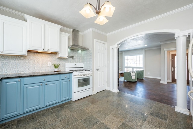 4005 Beaver Ave, Des Moines, IA 50310 - kitchen featuring wall chimney range hood, white gas stove, blue cabinets, arched walkways, and baseboards