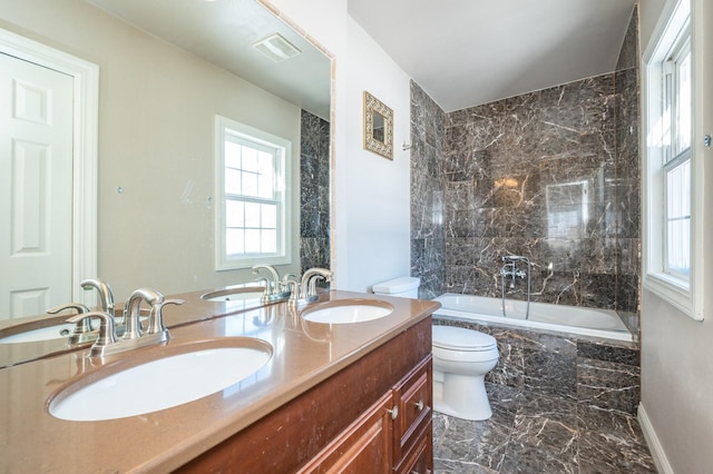 4005 Beaver Ave, Des Moines, IA 50310 - full bath featuring toilet, marble tiled flooring, double vanity, tiled shower / bath, and plenty of natural light