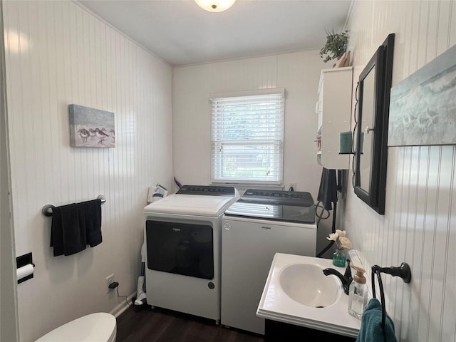 313 E 29th St S, Newton, IA 50208 - half bath featuring washer and clothes dryer, wood finished floors, toilet, and vanity