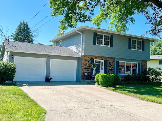 313 E 29th St S, Newton, IA 50208 - view of front of property featuring brick siding, a garage, concrete driveway, and a front lawn