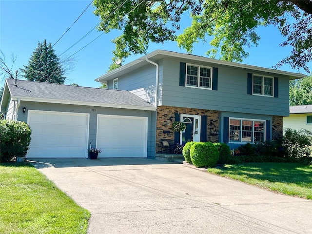 313 E 29th St S, Newton, IA 50208 - view of front of home with an attached garage, brick siding, concrete driveway, and a front yard
