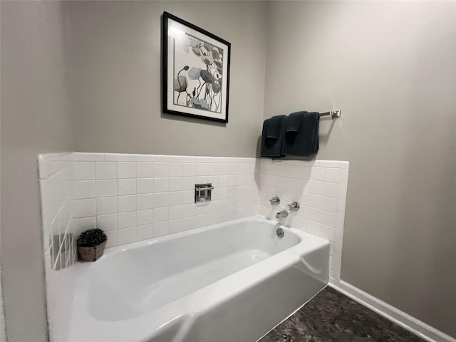313 E 29th St S, Newton, IA 50208 - bathroom with baseboards and a bath