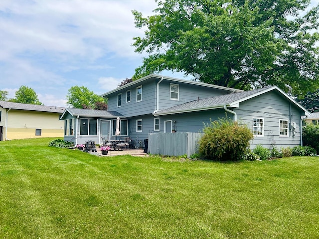 313 E 29th St S, Newton, IA 50208 - rear view of house with a patio area and a lawn