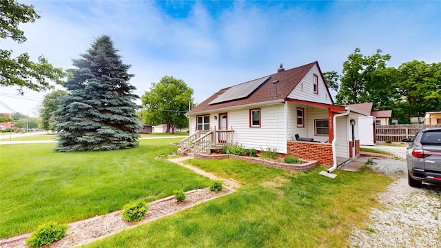 6465 NW 56th St, Johnston, IA 50131 - view of side of home featuring solar panels, a chimney, and roof with shingles