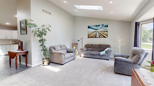 416 S Park St, Stuart, IA 50250 - living room with lofted ceiling, a skylight, light colored carpet, recessed lighting, and baseboards