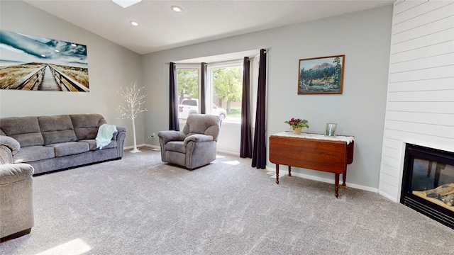 416 S Park St, Stuart, IA 50250 - carpeted living area featuring recessed lighting, vaulted ceiling, baseboards, and a fireplace