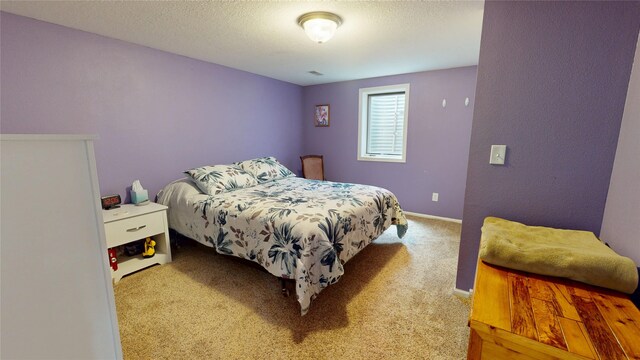416 S Park St, Stuart, IA 50250 - carpeted bedroom with a textured ceiling and baseboards