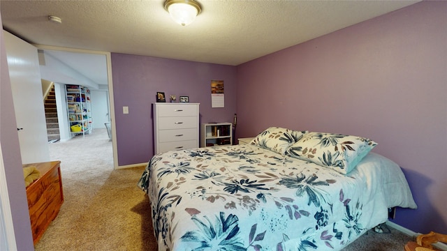 416 S Park St, Stuart, IA 50250 - bedroom with light carpet and a textured ceiling