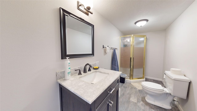 416 S Park St, Stuart, IA 50250 - full bath featuring vanity, toilet, a shower stall, wood finished floors, and a textured ceiling