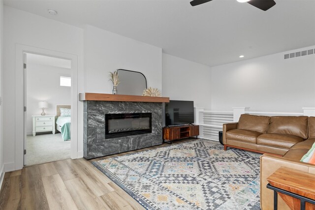 110 Bailey Cir, Waukee, IA 50263 - living room with wood finished floors, ceiling fan, a fireplace, and recessed lighting