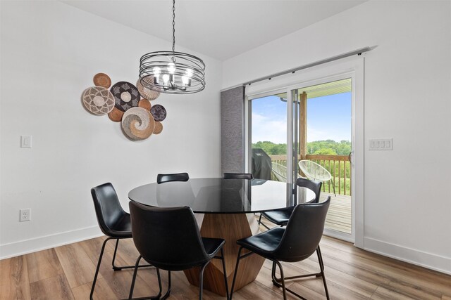 110 Bailey Cir, Waukee, IA 50263 - dining room with a chandelier, baseboards, and wood finished floors