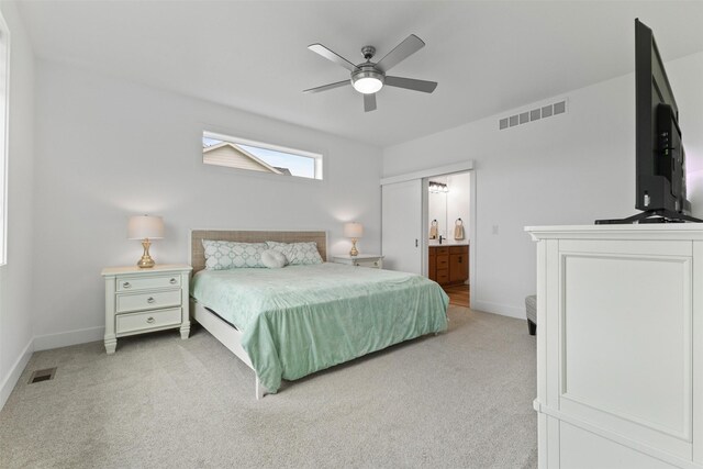110 Bailey Cir, Waukee, IA 50263 - bedroom featuring light colored carpet, baseboards, ensuite bathroom, and a ceiling fan