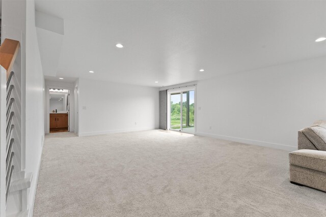 110 Bailey Cir, Waukee, IA 50263 - unfurnished living room with recessed lighting, light colored carpet, and baseboards