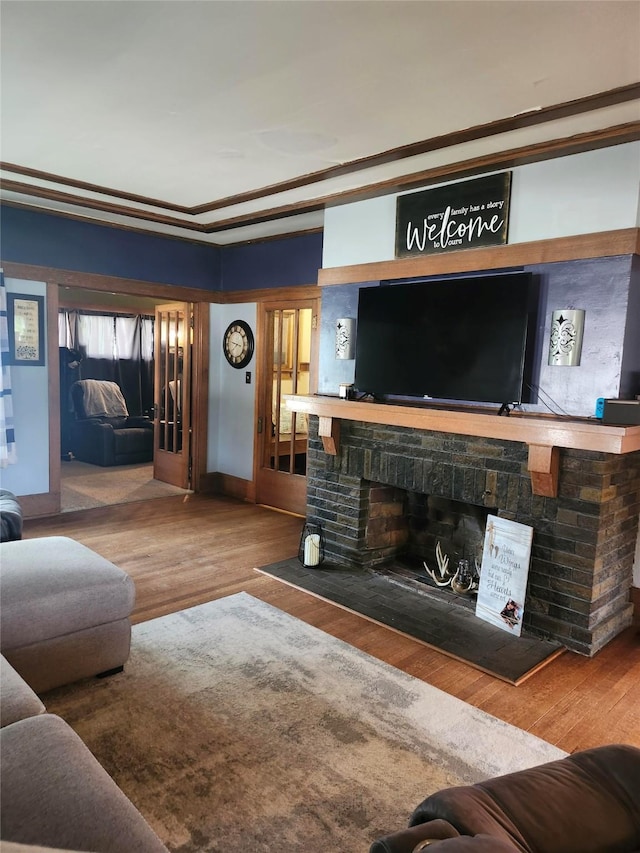 230 Grant St, Murray, IA 50174 - living room featuring wood finished floors, a brick fireplace, and ornamental molding
