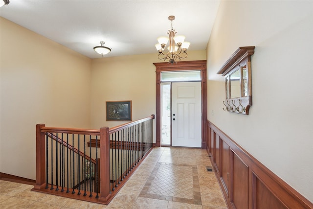 4014 NE Bellagio Cir, Ankeny, IA 50021 - foyer featuring a chandelier, a wainscoted wall, and a decorative wall