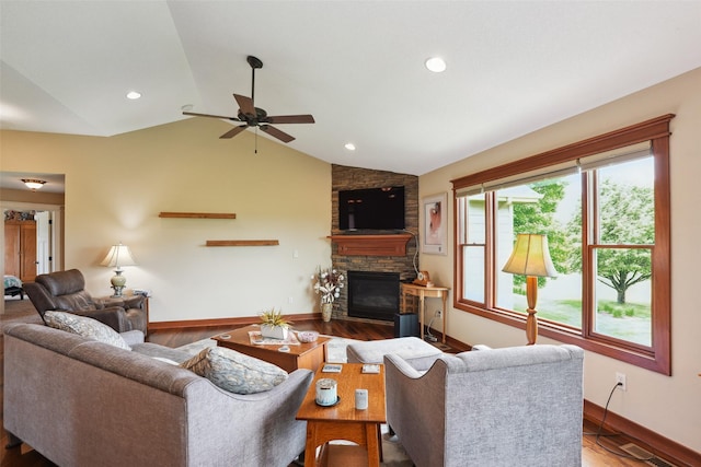 4014 NE Bellagio Cir, Ankeny, IA 50021 - living area featuring a stone fireplace, baseboards, vaulted ceiling, ceiling fan, and wood finished floors