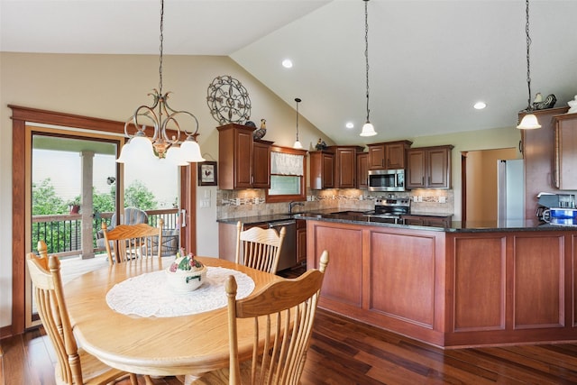 4014 NE Bellagio Cir, Ankeny, IA 50021 - dining room with a chandelier, plenty of natural light, dark wood-type flooring, high vaulted ceiling, and recessed lighting