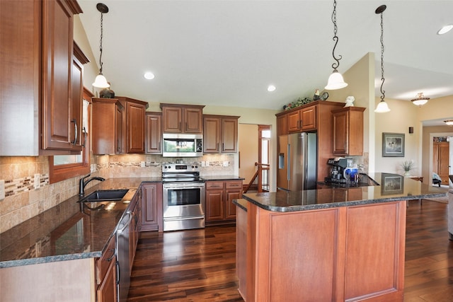 4014 NE Bellagio Cir, Ankeny, IA 50021 - kitchen with stainless steel appliances, a sink, dark wood-style flooring, backsplash, and decorative light fixtures