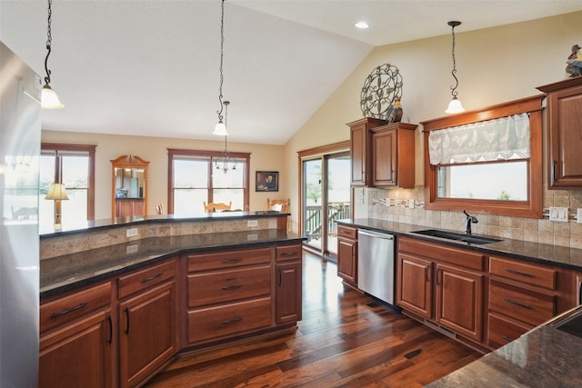 4014 NE Bellagio Cir, Ankeny, IA 50021 - kitchen featuring stainless steel appliances, a sink, dark wood finished floors, lofted ceiling, and backsplash