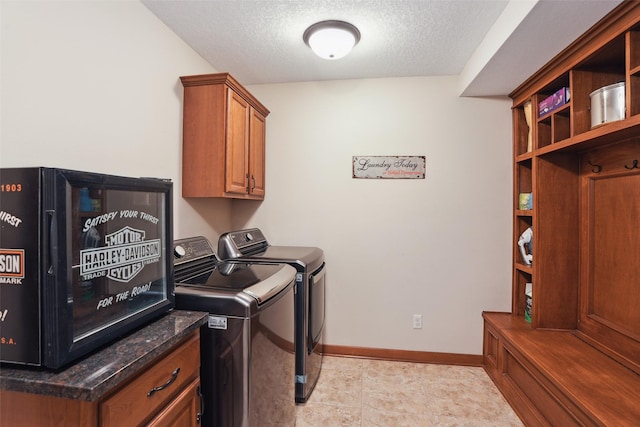 4014 NE Bellagio Cir, Ankeny, IA 50021 - washroom with a textured ceiling, washer and dryer, cabinet space, and baseboards