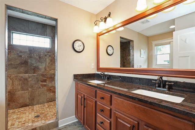 4014 NE Bellagio Cir, Ankeny, IA 50021 - full bathroom with double vanity, tiled shower, and baseboards