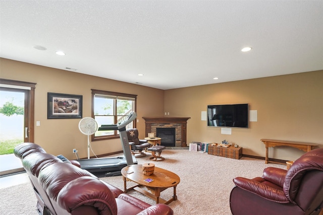 4014 NE Bellagio Cir, Ankeny, IA 50021 - living area with carpet floors, recessed lighting, a stone fireplace, and baseboards