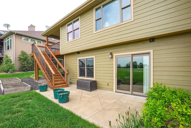 4014 NE Bellagio Cir, Ankeny, IA 50021 - back of house with a garden, a patio area, a lawn, and stairs