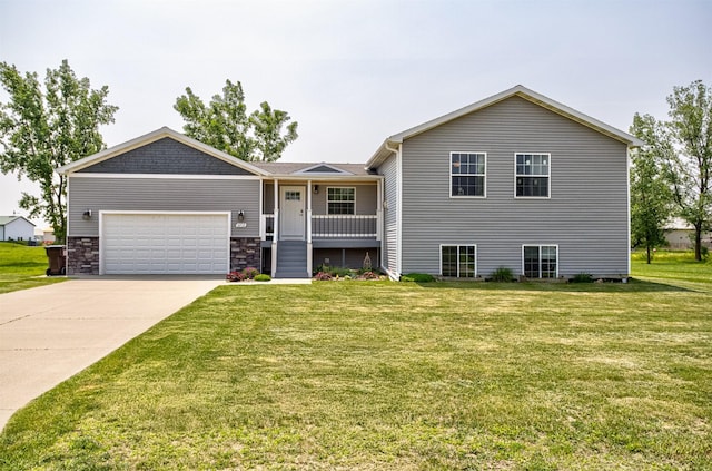 2212 228th Pl, Ames, IA 50014 - view of front of home featuring an attached garage, a front lawn, driveway, and a porch