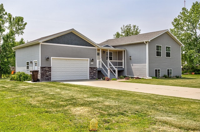 2212 228th Pl, Ames, IA 50014 - view of front of home with a garage, driveway, a front lawn, covered porch, and stone siding