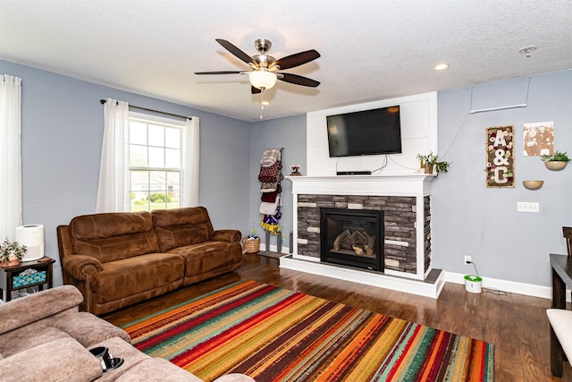 2212 228th Pl, Ames, IA 50014 - living area featuring baseboards, ceiling fan, a fireplace, wood finished floors, and recessed lighting